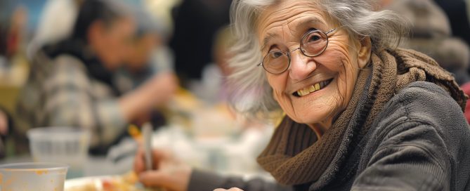 Happy elderly homeless woman eats free meal in dining hall