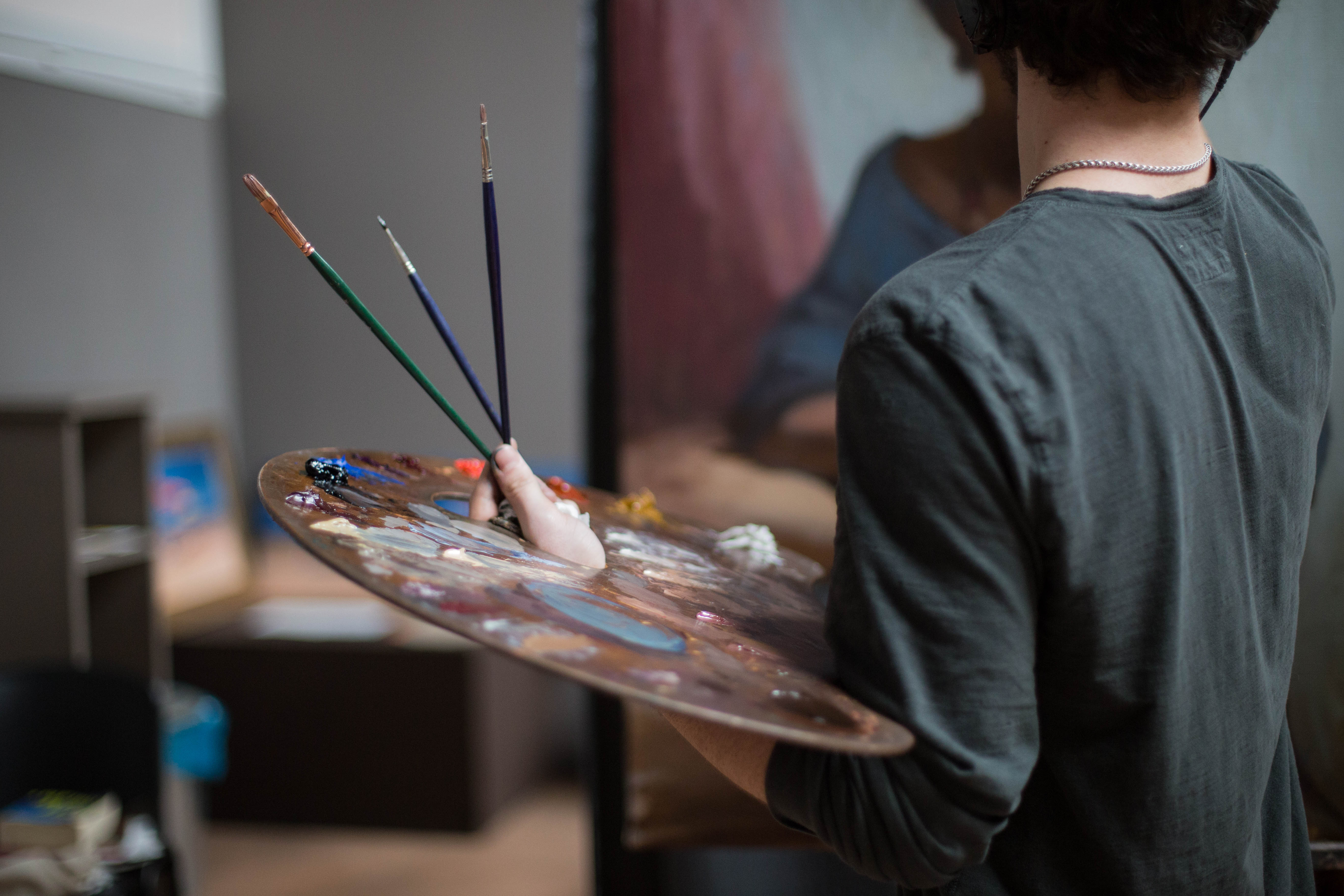 A student working on an oil paint study